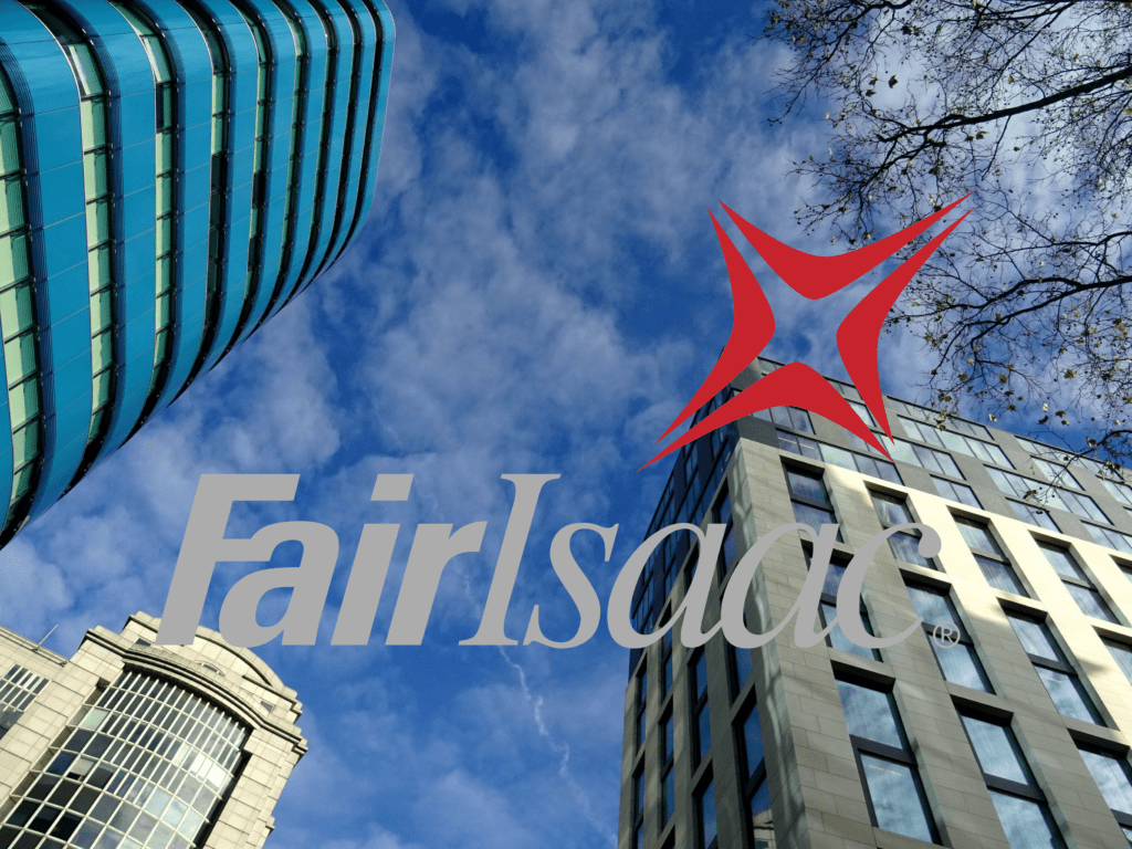 The image shows tall office buildings with the sky in the background and overlaying the image is a logo for the Fair Isaac company.